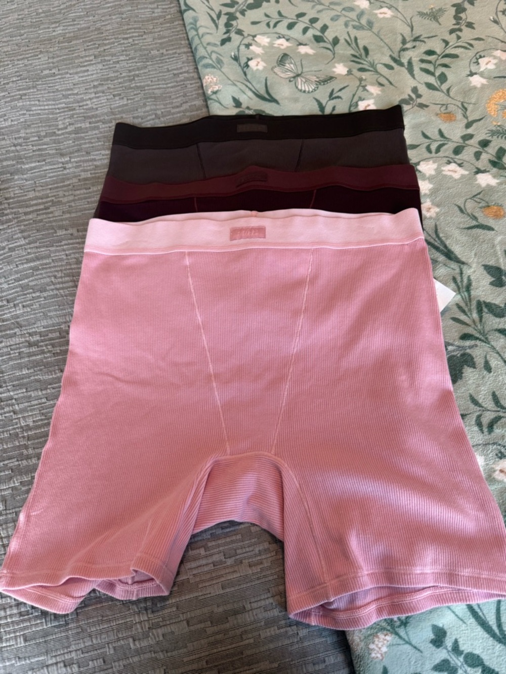 SKIMS set of three boxer and briefs in pink brown and burgundy color size large